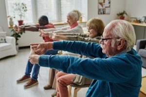 seniors on chairs exercising senior living fitness
