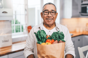 older adult holding groceries importance of nutrition