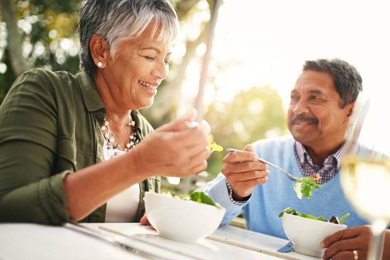 Happy Couple Enjoying Healthy Salad Bowls Outdoors