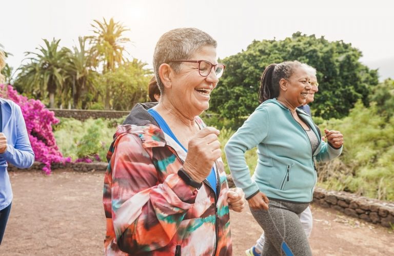 Older adults running outdoors.