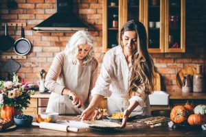 Older woman and daughter cooking.