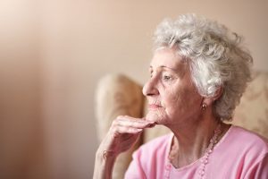 Older woman thinking alone