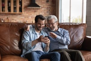 Man with older adult talking at home
