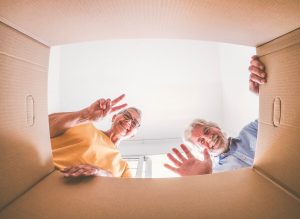 Couple of seniors saying Hi through a box