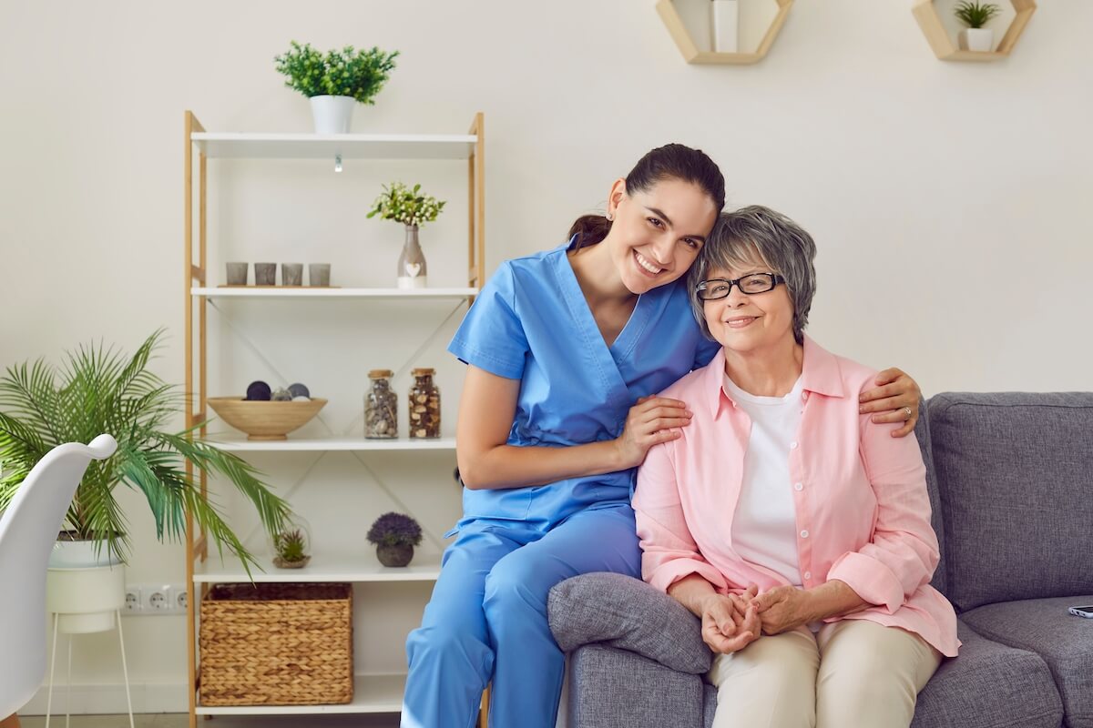 Caregiver hugging an older woman
