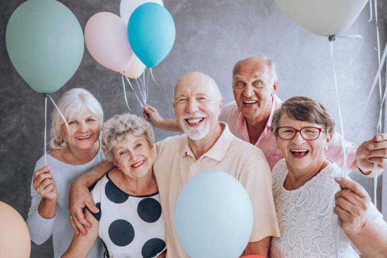 A group of seniors celebrating with balloons
