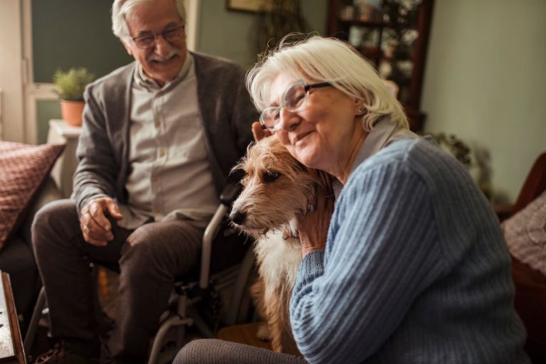 Seniors petting a small dog