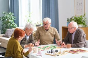 Seniors playing board games together