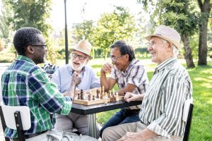 A group of seniors playing chess outside