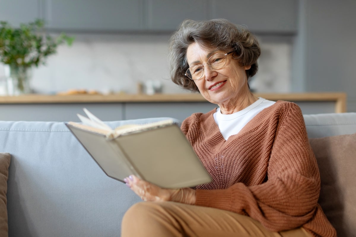 Older woman reading a book in senior living