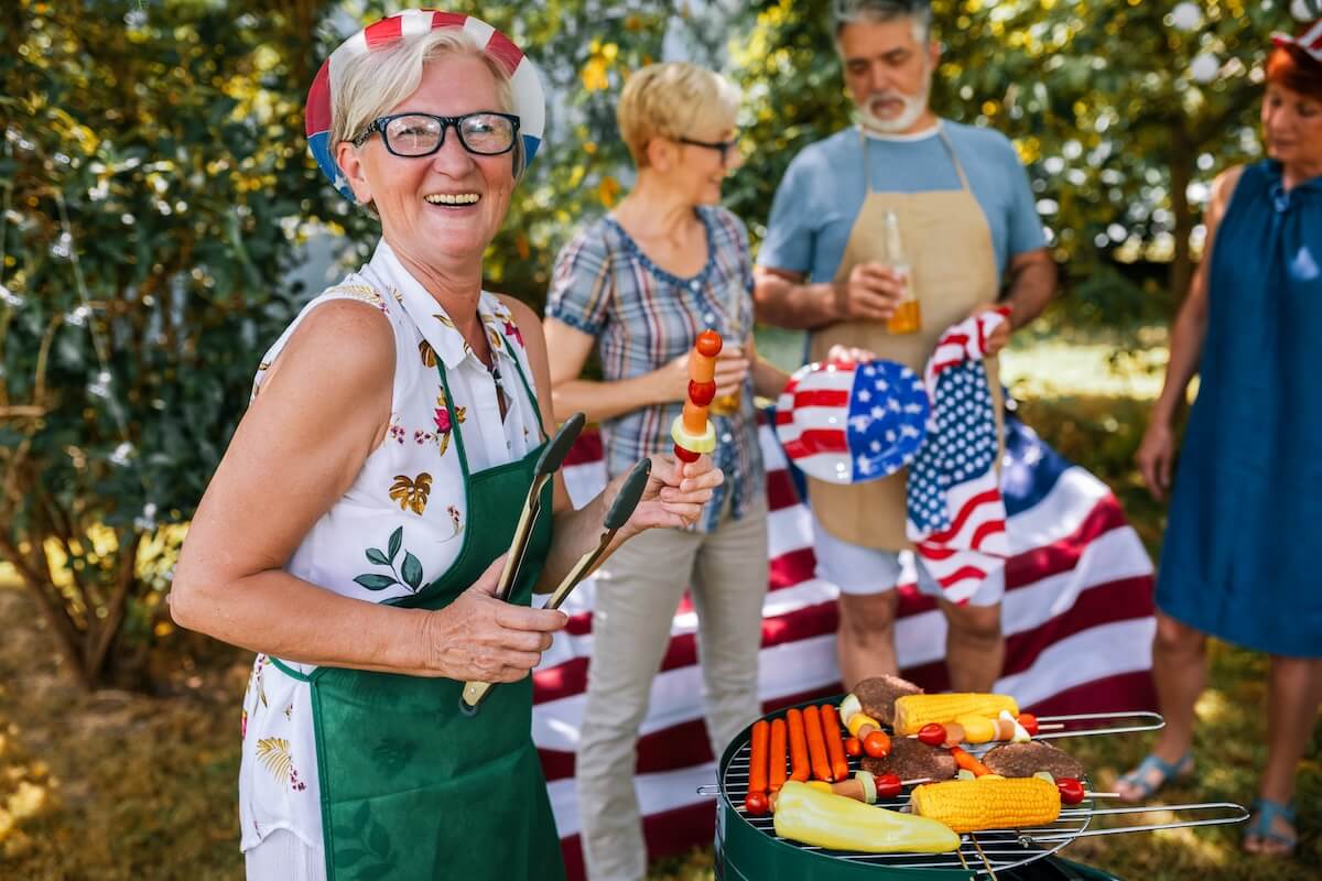 Smiling older woman at a 4th of July-themed BBQ