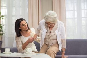 Adult daughter helping her elderly mother with mobility